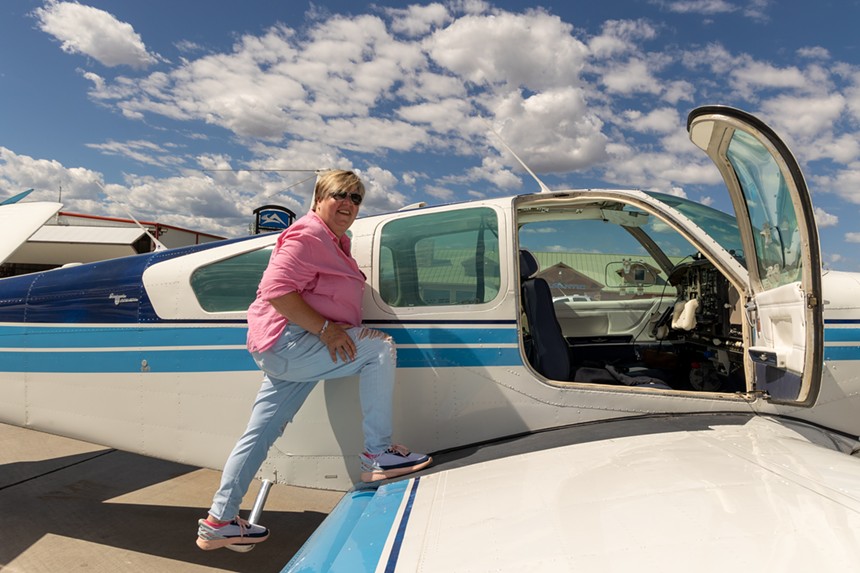 Woman entering a small plane.