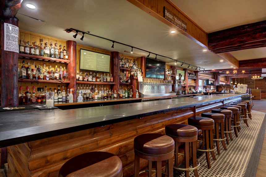 a bar lined with stools