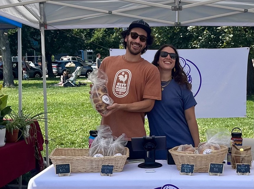 two people standing behind a table