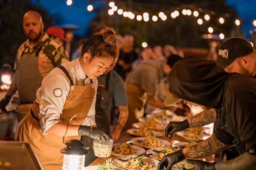 Several chefs plating a course during a Harvest Week dinner