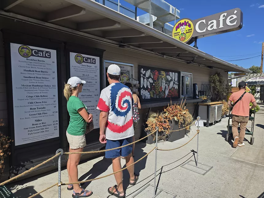 people standing in front of an ordering window