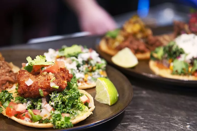 A variety of Teocalli Cocina street tacos served on two dishes