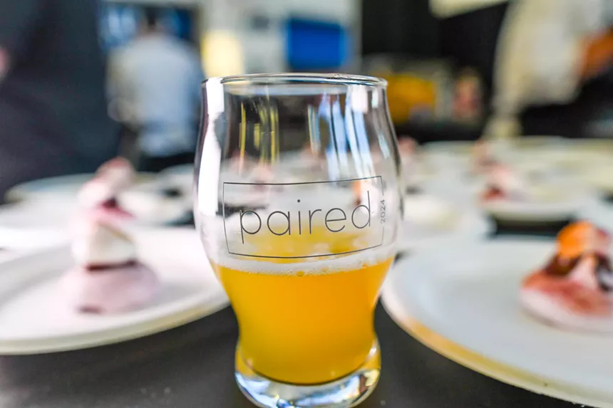 small tasting glass half full of beer