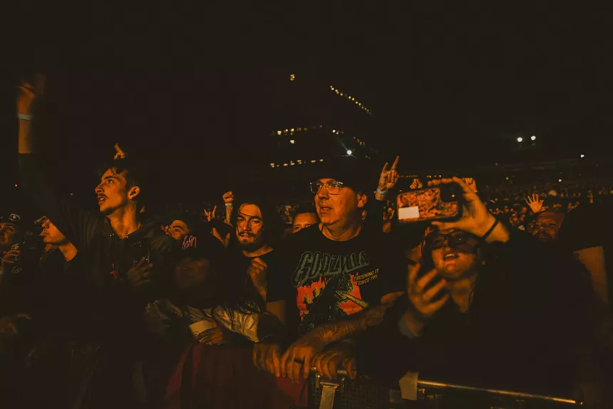 a crowd of people front row at a concert.