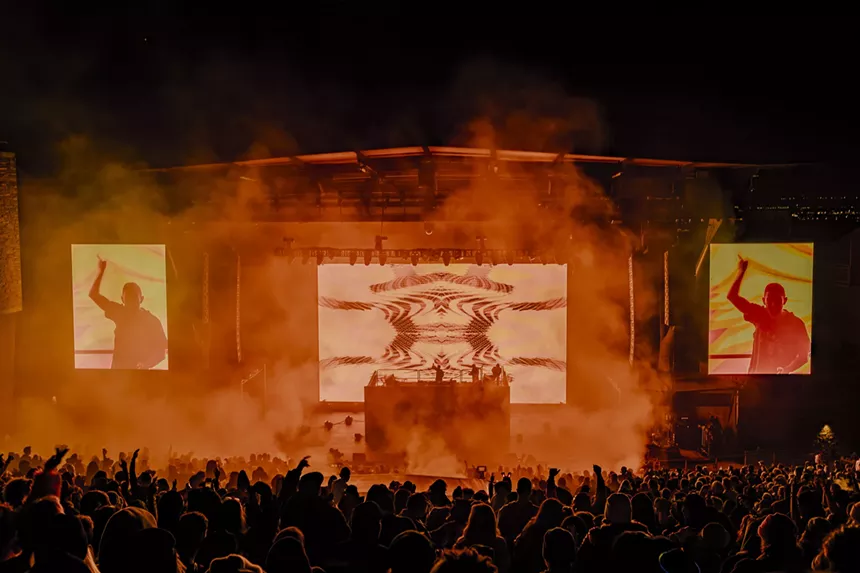 A photo showing a large stage with the artist Hamdi performing.