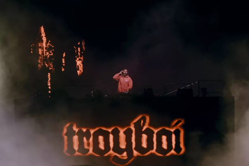 A photo showing Troyboi performing at Red Rocks with his name showing in his stage design.