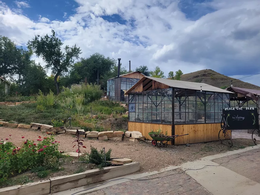 small glass house on a farm