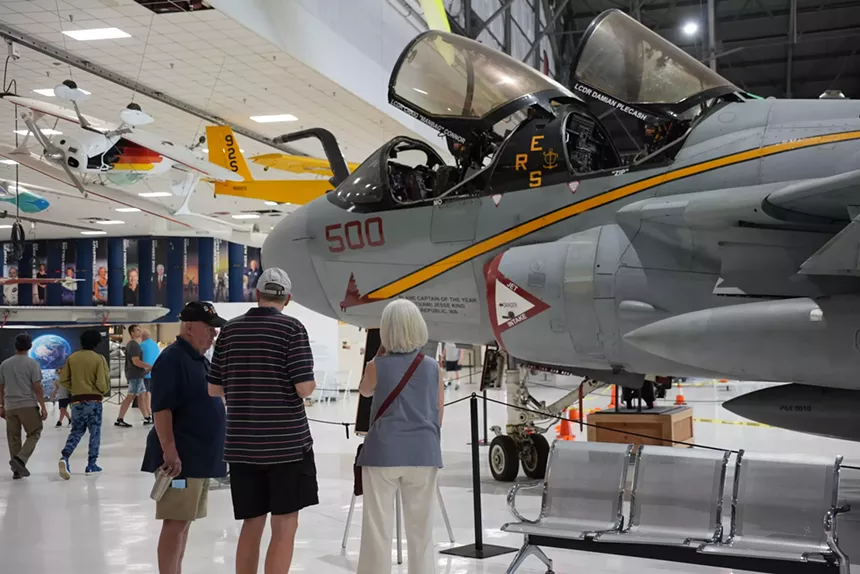 people looking at airplane