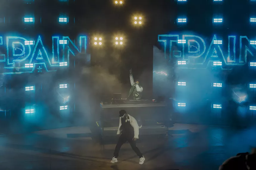A photo of T-Pain on stage performing at Red Rocks in Morrison, Colorado.