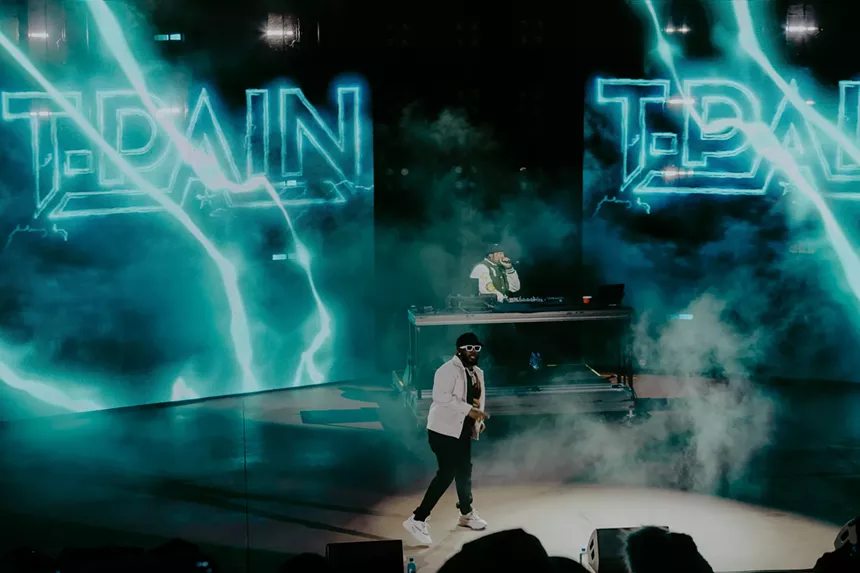 A photo of T-Pain on stage performing at Red Rocks in Morrison, Colorado.