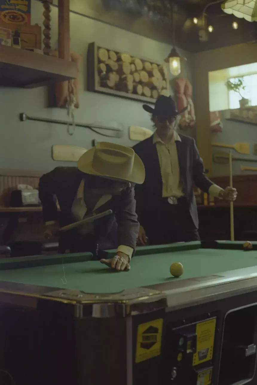 Kellen Wall and Bryce Menchaca of Marfa playing pool in a bar