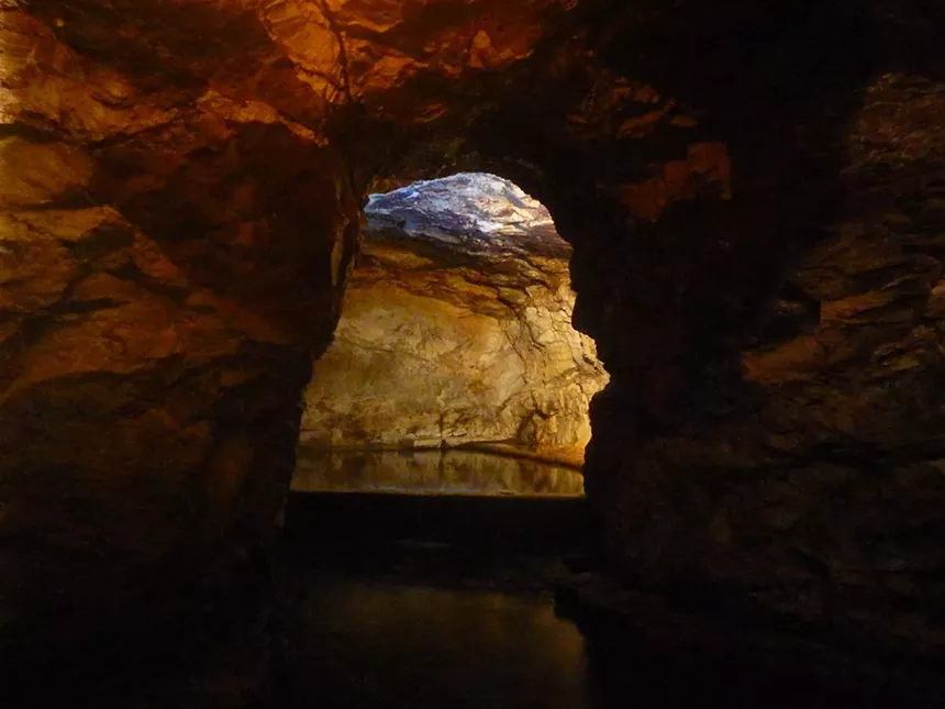 A dark cave with a shallow pool at Wiesbaden Hot Springs