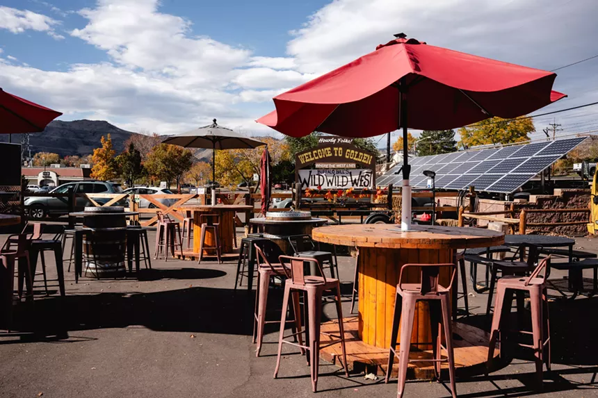 wooden tables with umbrellas outside