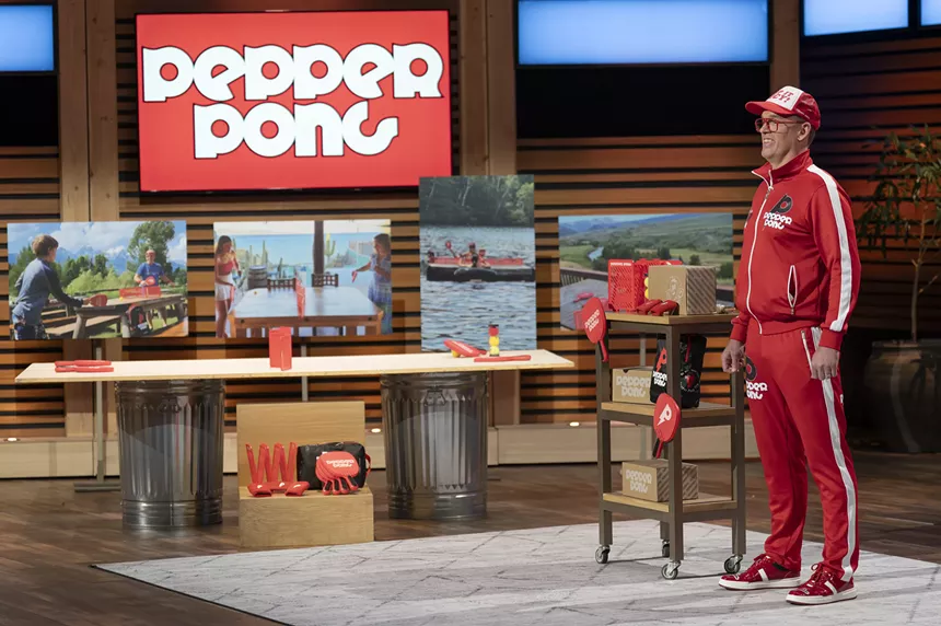 Man in red jump suit on television