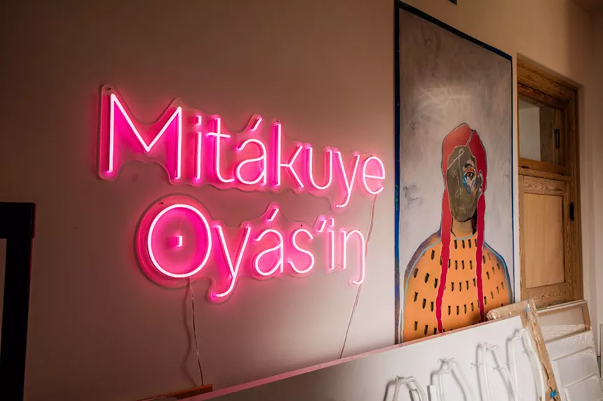 neon sign that reads Mitakuye Oyasin