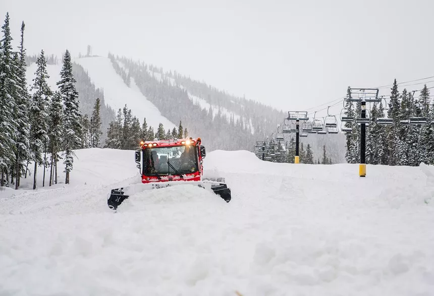 A snow groomer in deep powder at Winter Park Resort