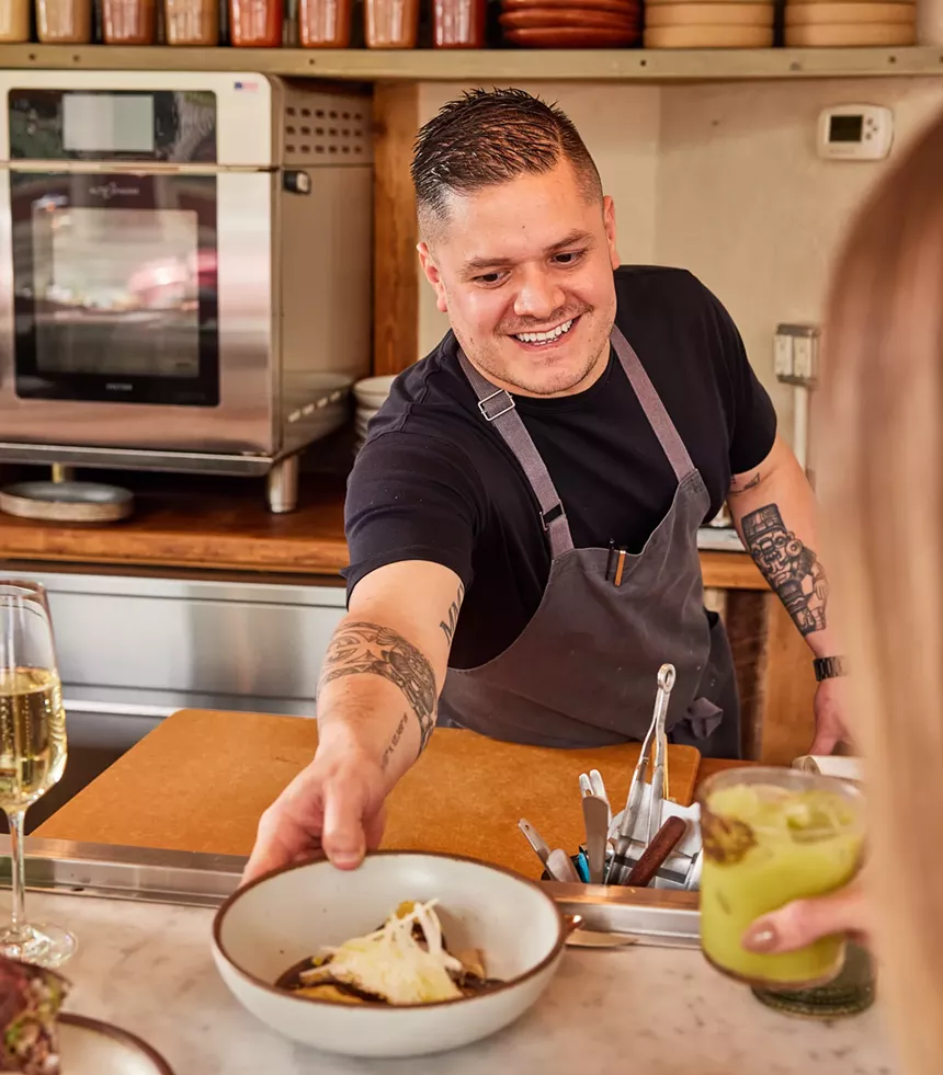 chef serving a plate of food
