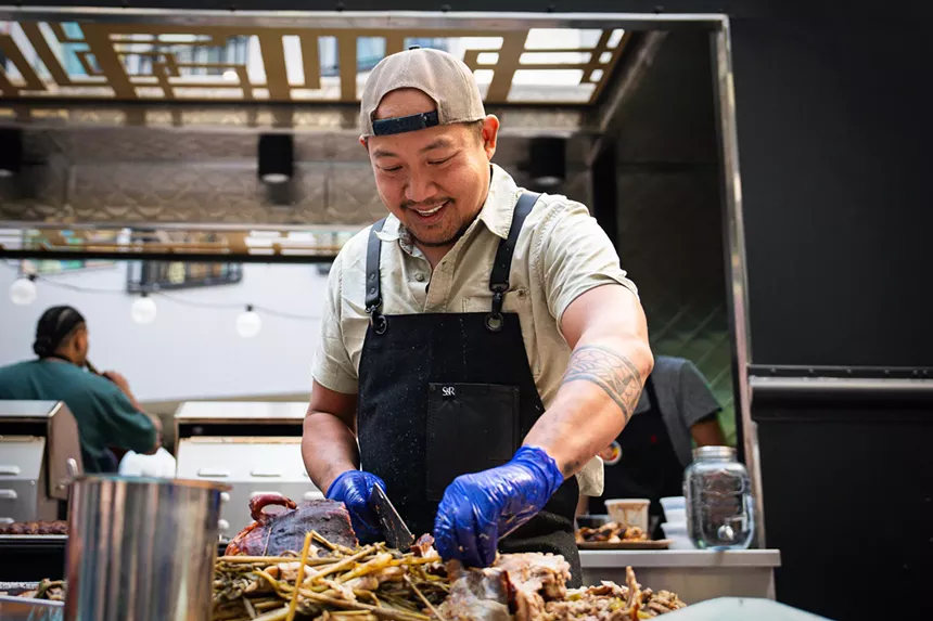 man in an apron cutting meat