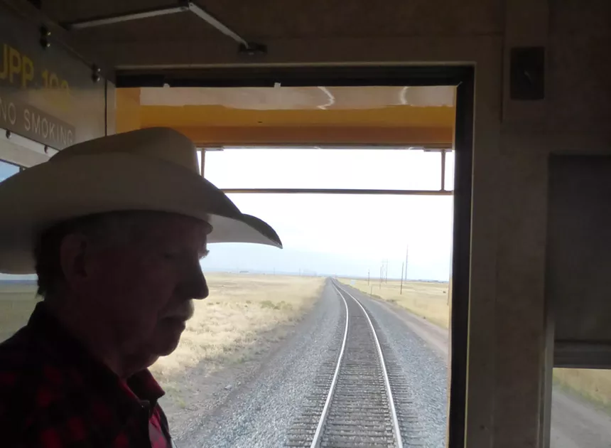 man in silhouette on train.