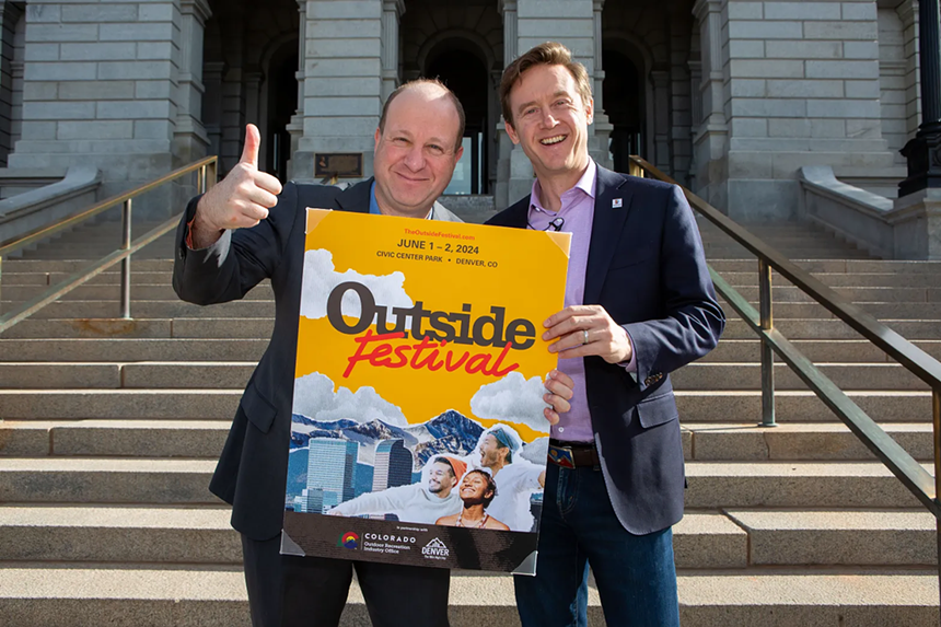 two men with sign for festival