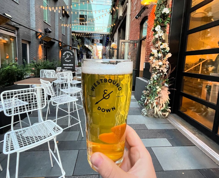 hand holding a glass of beer