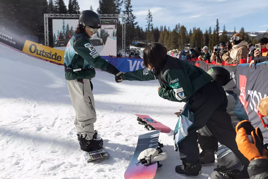 Snowboarders fist bump