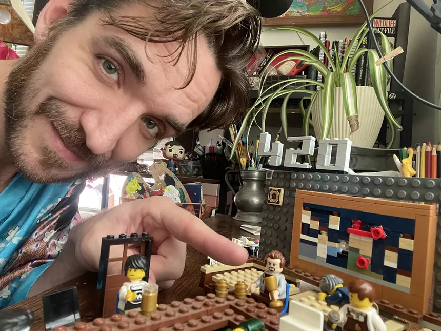 Zachary Lamb points at the miniature Lego version of himself in his LEGO replica of Nob Hill Inn