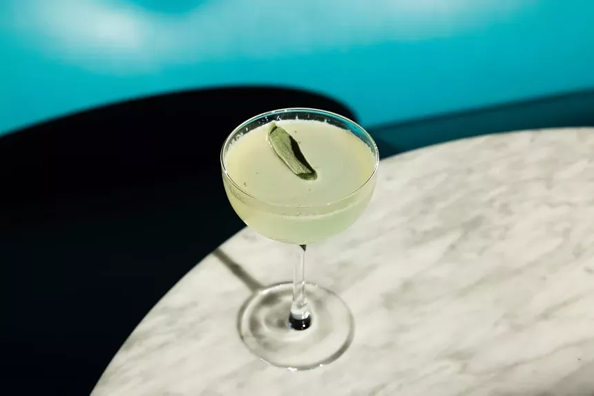 cocktail with a sage garnish