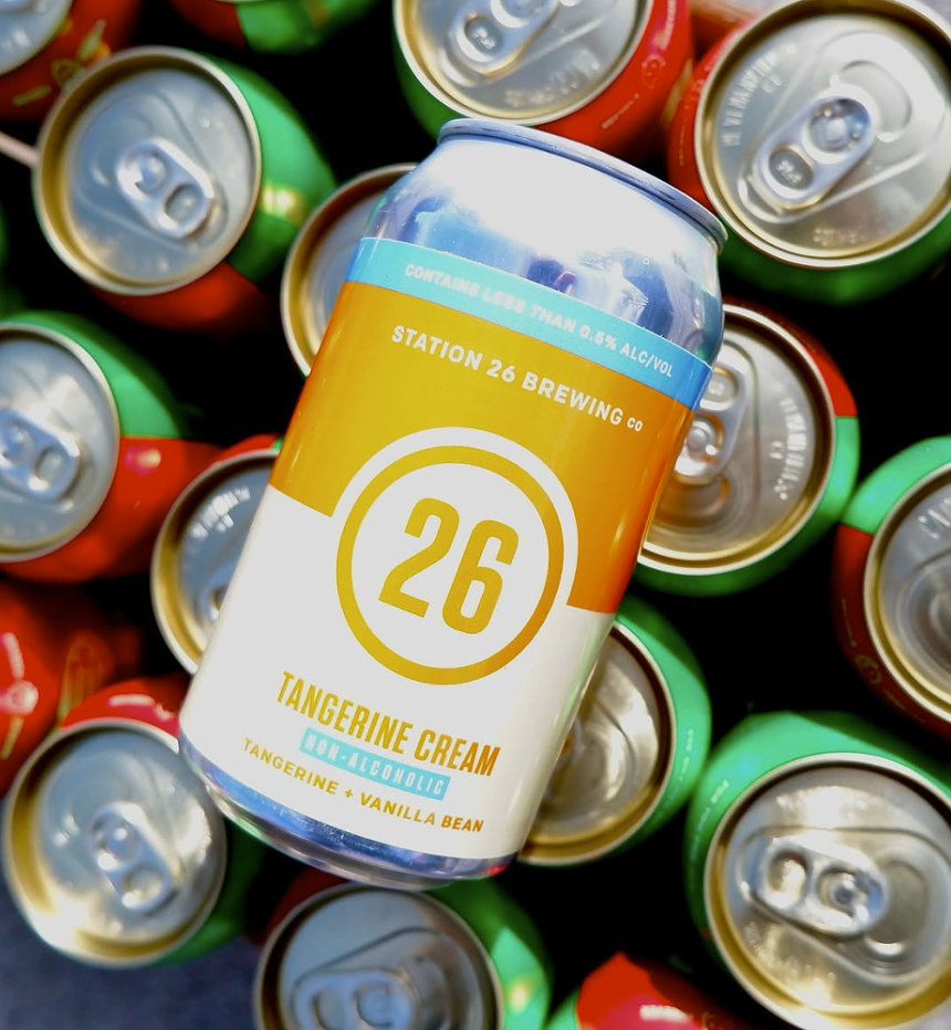 Can of non alcoholic beer resting on many more cans.