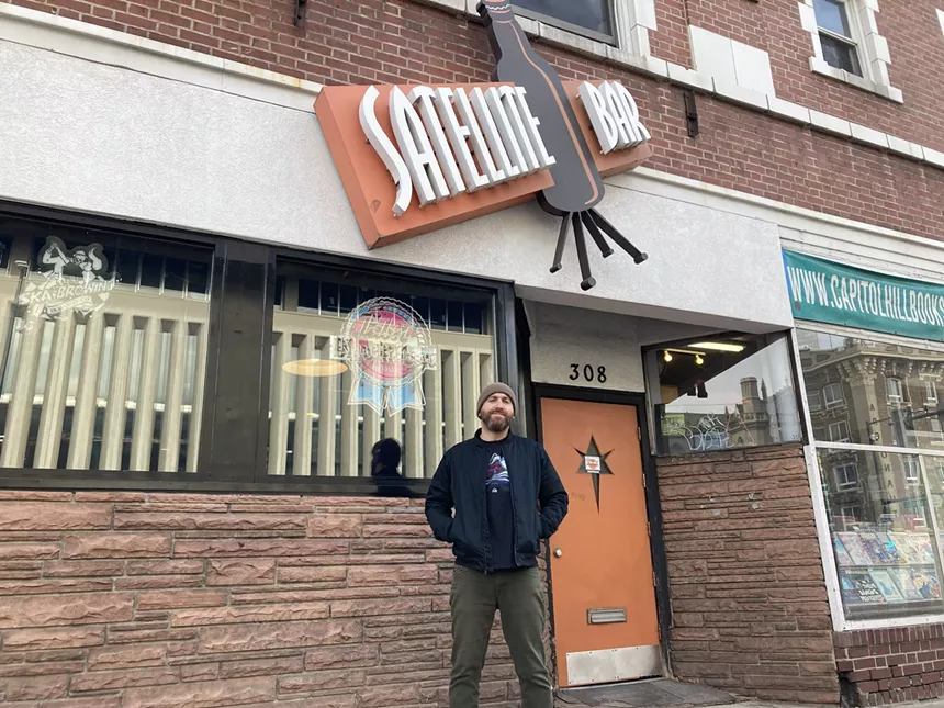 Michael John standing in front of the Satellite Bar.