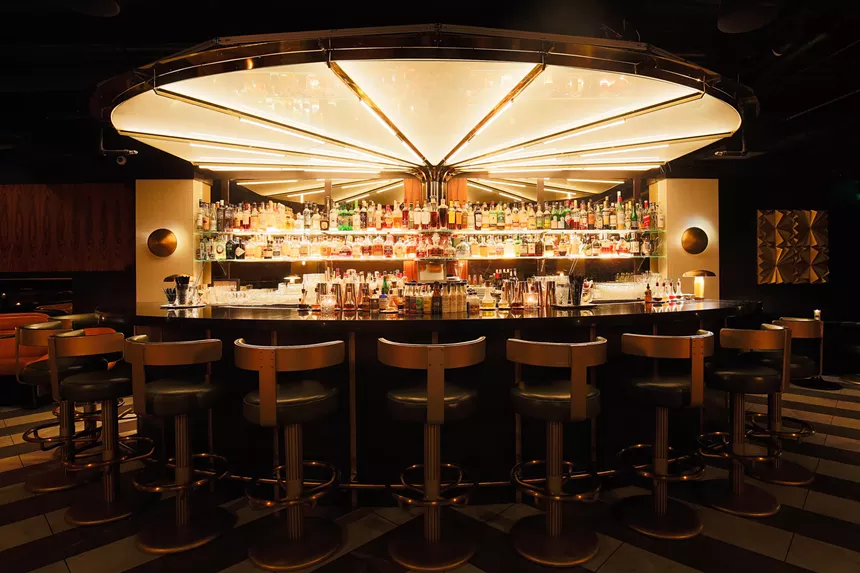 empty seats lined up at a bar