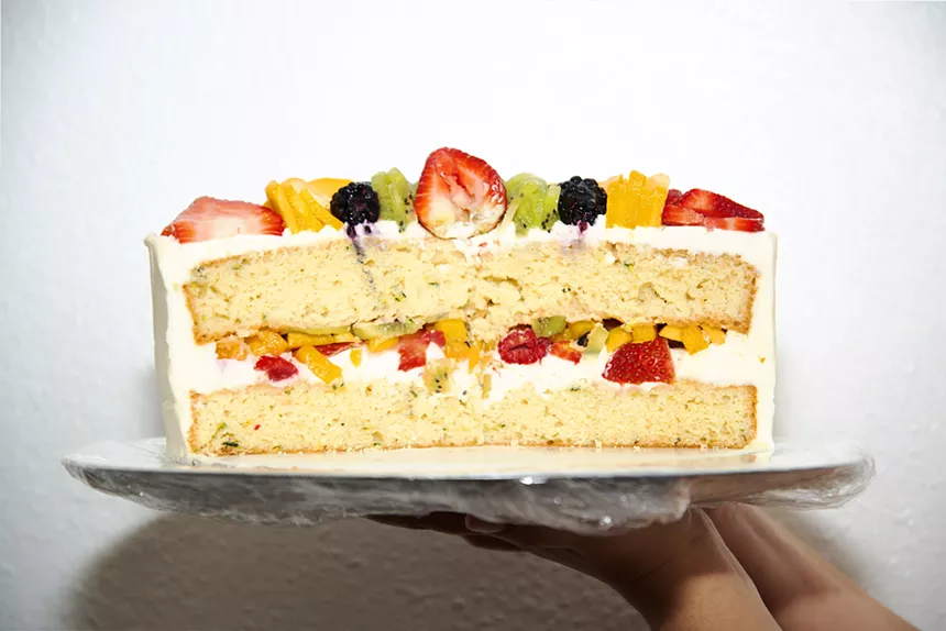 a white cake with fruit