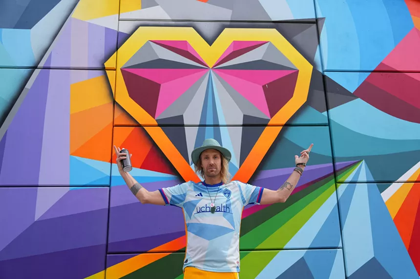 Pat Milbery in front of one of his heart murals