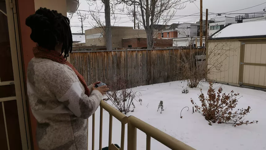 woman looking at backyard in snow