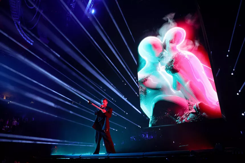 Justin Timberlake on stage holding a light bar