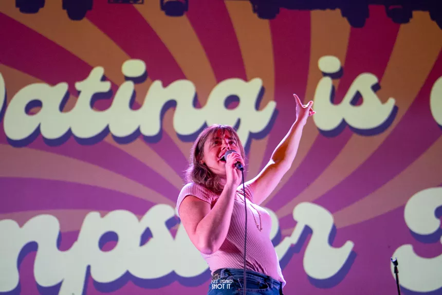 Dayna McTavish stands on stage during a prior performance of Dating is a Dumpster Fire.