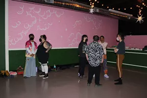Attendees stand inside Manos Sagrados.