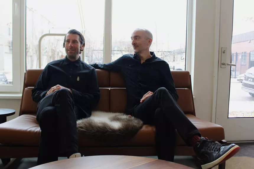 Two  men sit on a couch