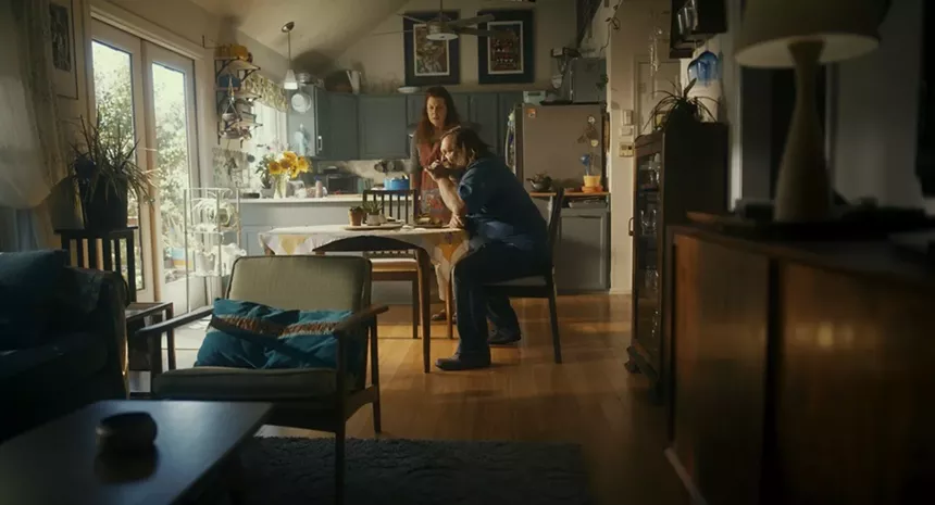 a man and woman in a kitchen