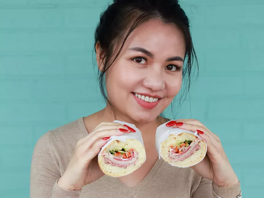woman holding banh mi