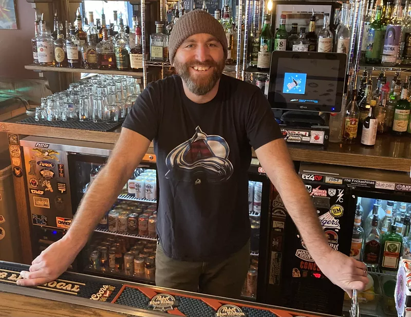 Michael John standing behind a bar