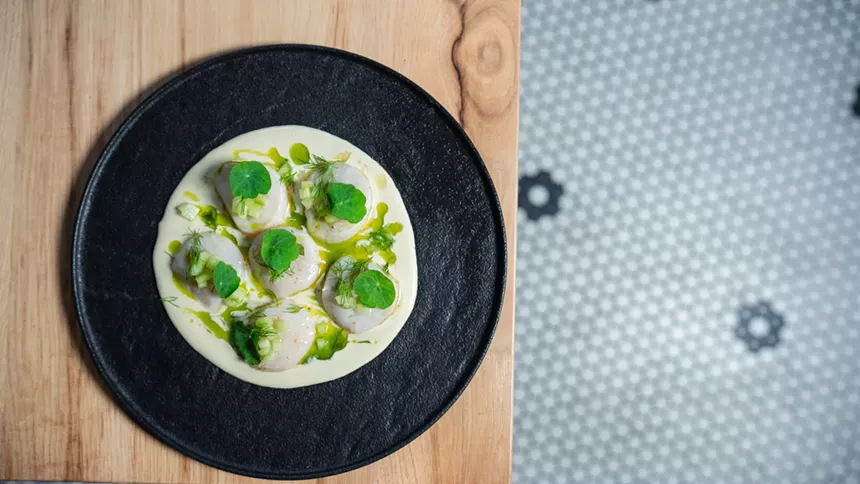 scallops on a black plate