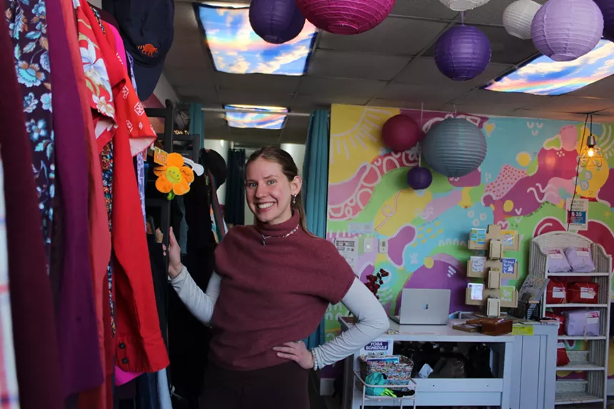 A woman stands in a clothing store