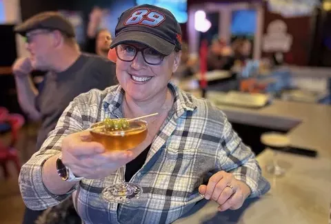 woman holding a martini