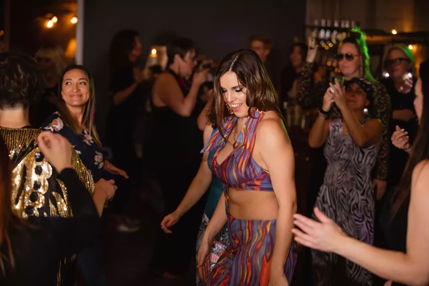 Women dance together.