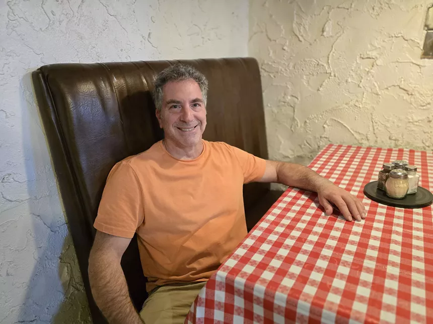 man sitting in a booth