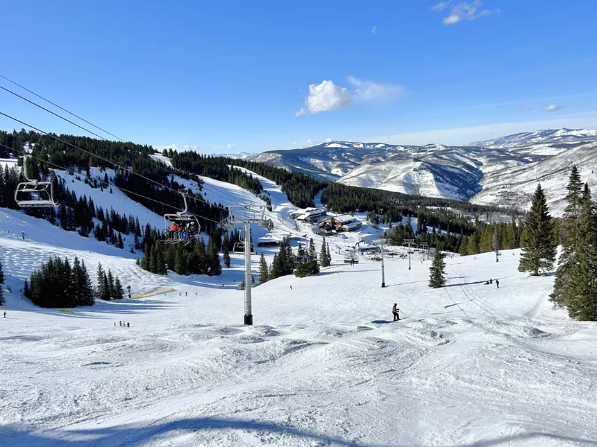 A ski lift backdropped by snowy mountains at Vail Ski Resort