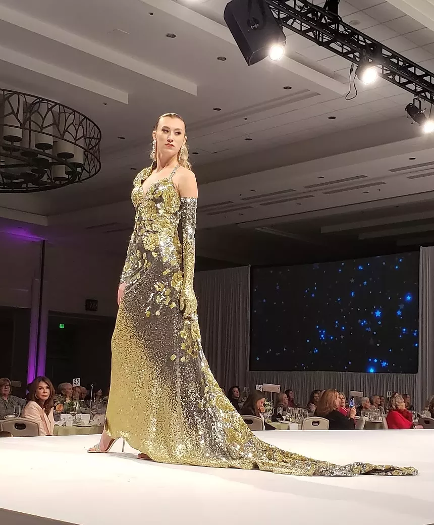 A model in a golden green dress