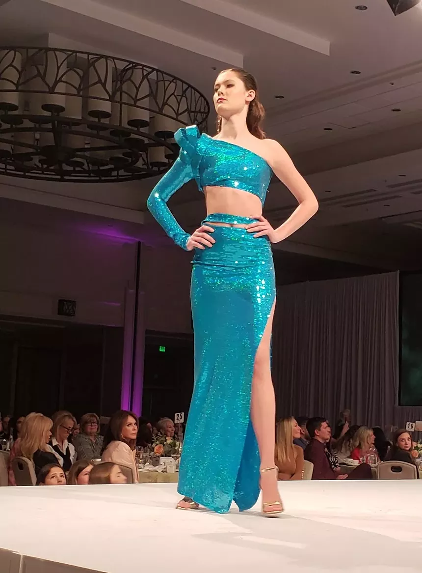 A model in a blue sparkly dress