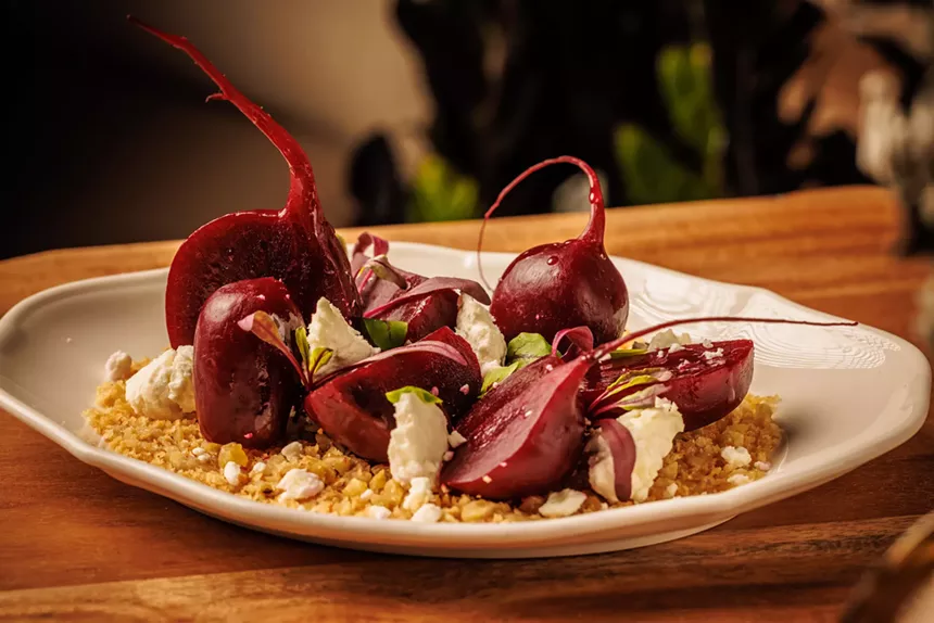 baby beets on a plate with goat cheese crumbles and breadcrumbs